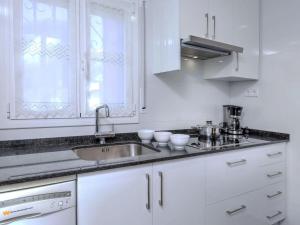 a kitchen with white cabinets and a sink at Villa Villa Mar by Interhome in Miami Platja