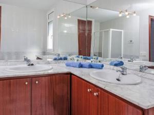a bathroom with two sinks and a large mirror at Villa Villa Mar by Interhome in Miami Platja