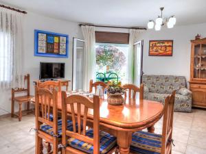 a dining room and living room with a table and chairs at Villa Villa Mar by Interhome in Miami Platja