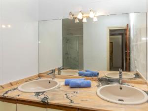 a bathroom with three sinks and a large mirror at Villa Villa Mar by Interhome in Miami Platja +14 photos