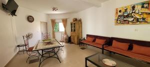 a living room with a couch and a table at Villa Saraba in Somone