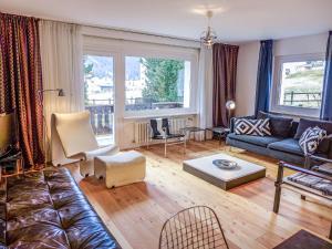 a living room with a couch and a table at Apartment Chesa Vuorcha by Interhome in Zuoz +14 photos