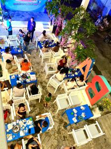 a group of people sitting in chairs on the beach at Babylon Hotel Phu Quy in Cu Lao Thu