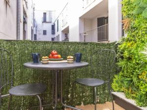 a table with chairs and a plate of fruit on it at Apartment Mitsu by Interhome in Tossa de Mar