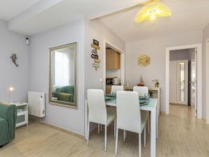 a kitchen and dining room with a table and chairs at Apartment Mitsu by Interhome in Tossa de Mar