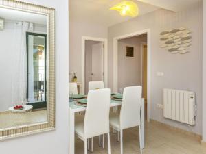 a dining room with a table and a mirror at Apartment Mitsu by Interhome in Tossa de Mar