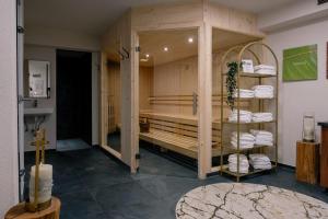 a room with a tub with towels in it at Alpine B&B including summercard in Plangeross +69 photos