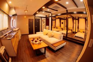 a living room with a couch and a table at La Station in Bibai