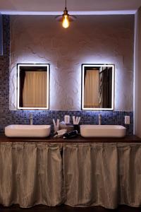 two sinks in a bathroom with two mirrors at La Station in Bibai +18 photos