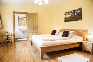 a bedroom with a large bed and a bathroom at Gästezimmer & Weingut Gamser in Leutschach