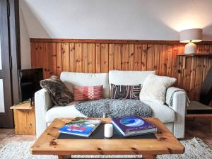 a living room with a couch and a coffee table at Apartment Plan Névé 5 by Interhome in Villars-sur-Ollon