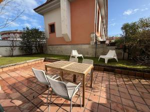 a table and chairs on a brick patio at Cala Tatina in Celorio