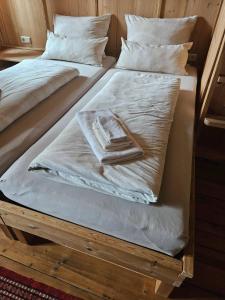 two beds with white blankets and pillows on them at VillaFrancesca - Emanuela/Raffaela in Zell am Ziller