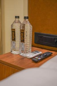 two bottles of water and a remote control on a table at Benchmark Residences in Indore +34 photos