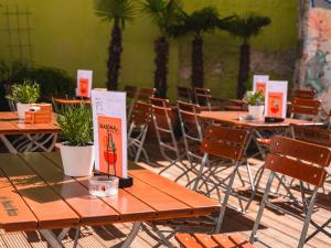 a group of tables and chairs with plants on them at Ballhaus Berlin Hostel in Berlin