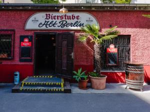 a red building with a entrance to a restaurant at Ballhaus Berlin Hostel in Berlin