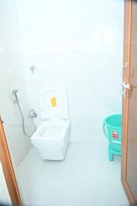 a bathroom with a toilet and a bidet at THE Temple View ''Near Kashi Vishwanath'' in Varanasi