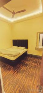 a bedroom with a bed with a ceiling at THE Temple View ''Near Kashi Vishwanath'' in Varanasi