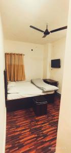 a bed in a room with a ceiling fan at THE Temple View ''Near Kashi Vishwanath'' in Varanasi
