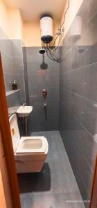 a bathroom with a toilet and a sink at THE Temple View ''Near Kashi Vishwanath'' in Varanasi +9 photos