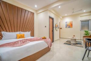 a bedroom with a large bed with a wooden headboard at Benchmark Residences in Indore