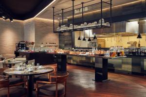 a restaurant with tables and chairs in a kitchen at Hilton Belgrade in Belgrade