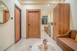 a living room with a couch and a table at Benchmark Residences in Indore