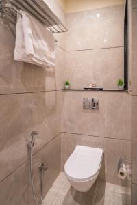 a bathroom with a toilet and a shower at Benchmark Residences in Indore