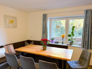 a dining room with a wooden table and a window at Apartment Benjamin by Interhome in Hollersbach im Pinzgau