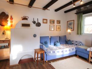 a living room with a blue and white couch at Chalet Hüttl by Interhome in Trins