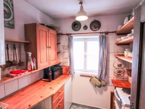 a kitchen with wooden cabinets and a window at Chalet Hüttl by Interhome in Trins +52 photos
