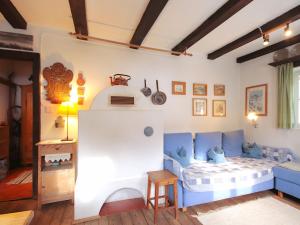 a room with a bed and a couch in it at Chalet Hüttl by Interhome in Trins