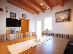 a large room with a table and a television at Holiday Home Bergblick by Interhome in Kappl