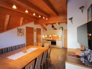 a kitchen and dining room with a large wooden table at Holiday Home Bergblick by Interhome in Kappl +67 photos