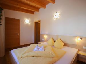 a bedroom with a bed with two white towels on it at Holiday Home Bergblick by Interhome in Kappl