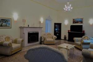 a large living room with couches and a fireplace at B&B luxury San Giuseppe in Gerace