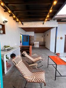 a patio with chairs and a table and a couch at Casa vacacional SAMUEL in Honda