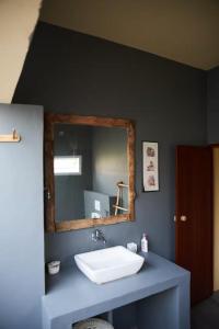 a bathroom with a sink and a mirror at House StoneHaven in Kaniyāmbetta +14 photos