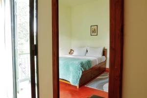 a bedroom with a bed and a mirror at House StoneHaven in Kaniyāmbetta