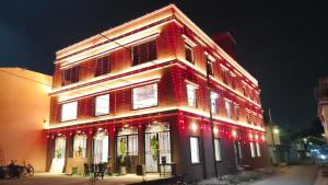 a lit up building with christmas lights on it at City Palace Sagar in Sāgar