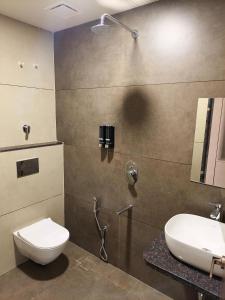 a bathroom with a toilet and a sink at City Palace Sagar in Sāgar +17 photos