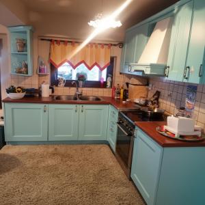 a kitchen with blue cabinets and a sink at Amadrias Villa Florina in Florina +28 photos