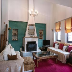 a living room with a couch and a fireplace at Amadrias Villa Florina in Florina