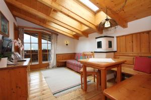 a living room with a table and a couch at Familien- und Vitalhotel Mühlpointhof in Lofer