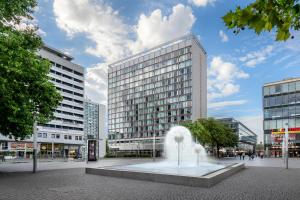 a fountain in the middle of a city with buildings at Barceló Dresden Newa in Dresden