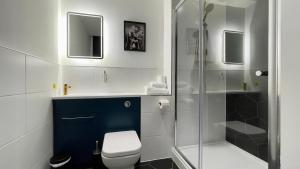a bathroom with a toilet and a glass shower at The Old Post Office Warrington by Deuce Hotels in Warrington +15 photos