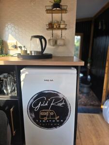 a refrigerator with a sign on the top of it at Tin Town Glamping in Haenertsburg