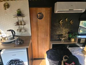 a room with a kitchen with a sink and a stove at Tin Town Glamping in Haenertsburg +5 photos
