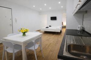 a kitchen and living room with a table and chairs at Maison TRENCA - fully equiped apartment in Menton