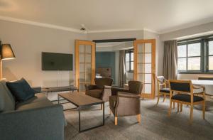 a living room filled with furniture and a flat screen tv at Scandic Hafjell in Hafjell